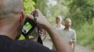 Photographer shooting a couple in the forest - Free Stock Video