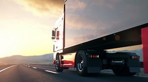 clip-1009727831-semi-truck-passes-camera-driving-on-highway