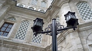 lamp in the garden of a mosque. historical mosque in the background. istanbul mosques close-up cinematic