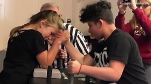 Intense armwrestling battle sees young girl emerge victorious over boy