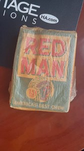 This sealed pouch of Red Man Tobacco has a Yogi Berra card on the back! These ‘50s packs were some of the last vestiges of the association between tobacco and baseball cards. This one finds a new home tomorrow https://sports.ha.com/itm/baseball-cards/unopened-packs-display-boxes/1954-red-man-tobacco-pack-with-yogi-berra-card-on-back/a/70019-58982.s?Type=social-sports-facebook-RedManPack-032825 | Heritage Auctions Sports