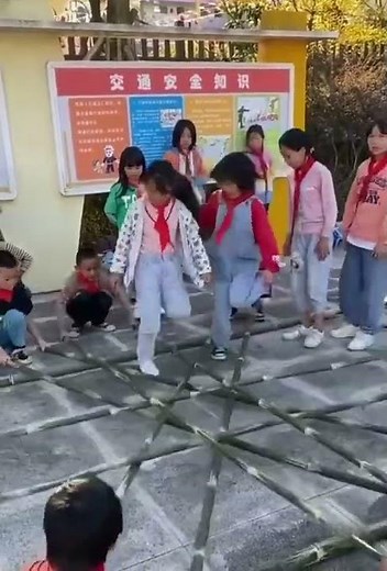 Traditional bamboo stick game and dance at the playground...