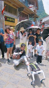 During the May Day holiday, a robot police dog patrolled the streets of Yangshuo — and instantly became a crowd favorite! Tourists couldn’t get enough of this futuristic “canine cop.” Would you stop for a selfie? #Yangshuo #GuilinVibes #SmartCity #RobotDog #TechInChina #MayDayHoliday | Discover Guilin | Facebook