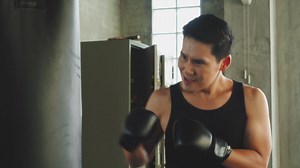 Download Asian athletic man boxing at gym. for free