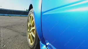 Professional race driver testing engine power and car aerodynamics on road