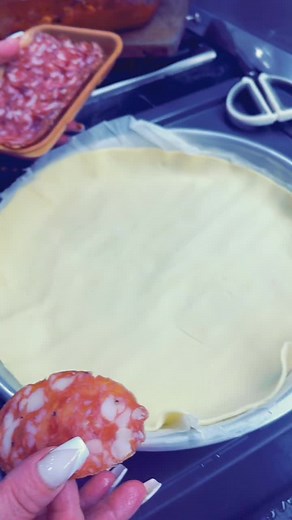 Preparing Delicious Pizza with Salami and Mozzarella