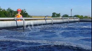 An engineer controlling a quality of water ,aerated activated sludge tank at a waste water treatment plant. pollution