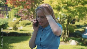 Woman Receiving Bad News on Phone in Park. Visibly upset and distressed.Emotional distress, bad news, and grief in public setting.