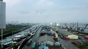 Traditional industrial port with containers from top view or aerial view. It is an import and export cargo port at Sunda Kelapa - Jakarta. 2.7K resolution video