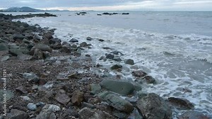 Small waves lapping and receding on rocky beach in Rosslyn Bay on Queensland’s Capricorn Coast, Australia
