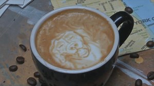 Coffee artist creates latte art in Midtown for International Coffee Day