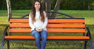 Woman Sitting On a Park Bench