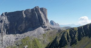 Aerial Mountains in the Alps, Outdoor adventures on steep Rocks and Wilderness on high altitude. Alps seen from above. Flying over steep Valley toward Mountain. Rock Climbing on Rock Face