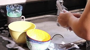 close up of hand doing dish washing in the modern kitchen sink. High quality 4k footage