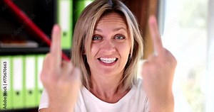 Portrait of crazy angry woman with middle finger rude gesture. Face of woman full of hate and resentment