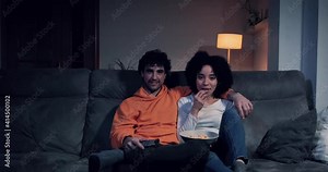 Couple on the sofa at home watching a movie or series on tv