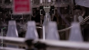 Sauce production line. Semi-transparent plastic bottles moving through the production line. Automatic line for processing of sauce.