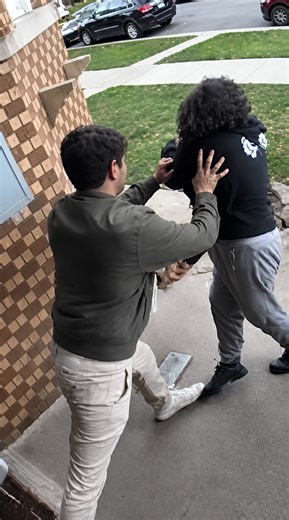 Video shows Nick Fuentes pushing woman at his door