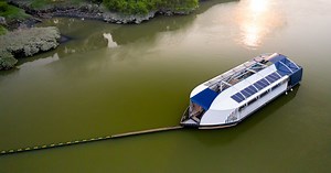 the ocean cleanup unveils floating garbage truck that catches plastic in rivers