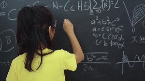 clip-1034128583-pretty-female-elementary-school-student-writing-triangle