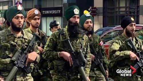 Canadian soldiers march with weapons at Toronto Khalsa Day Parade