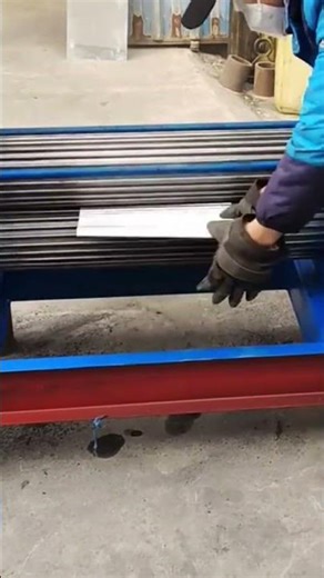 bending the silver metal sheet precisely using a professional electric power roller machine today