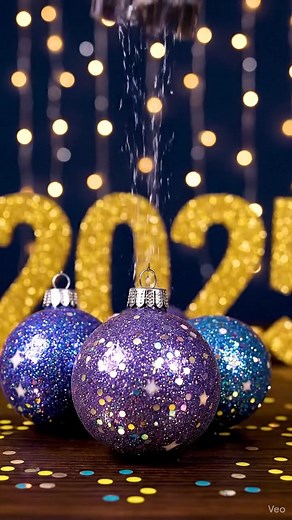 🎆✨ Ring in the New Year with Sparkling GOLD Galaxy Ornaments! This craft is perfect for New Year's Eve décor — shimmering, glowing, and cosmic. Ingredients: Clear ornaments Baking soda Black, blue, purple, and gold acrylic paint Gold holographic glitter Cotton swabs Instructions: Add 2 tsp baking soda to each ornament. Add drops of black, purple, and LOTS of gold paint. Swirl until you get a galaxy with a champagne-gold glow. Add glitter to represent fireworks in space. Let dry and hang beside 