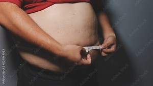 Overweight man's belly,fat man has excess fat, he is dieting and losing weight.unhealthy,medical health concept with copy space space for text