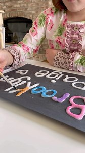 Here’s a fun way for your child to work on learning the letters in their name! On paper (cardstock works best but other paper works too) , use washable glue to write out a name. Pour salt all over and shake off the excess. Let it dry for a few minutes. Use watercolor paint (with a wet paintbrush) to tap colors onto the salt covered glue. Watch how the colors spread- it’s pretty magical. Follow our page for more activity ideas that make learning fun! #letterrecognitionactivity #kidsartideas #kids
