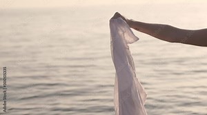 woman drops a white shirt into the water