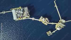 Central processing platform (cpp) in the middle of the ocean on sunny day - upstream industry