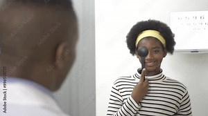 African teen girl reading eye chart during distance vision exam, health concept. Stock Video
