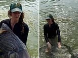 Samantha Strable is seen catching Siamese giant carp