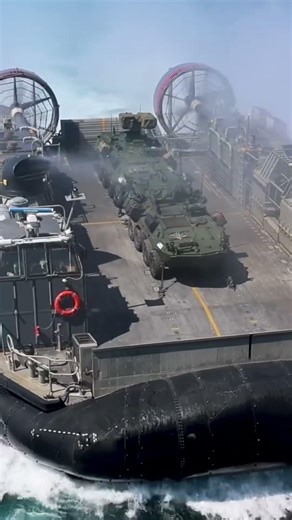 LCAC carrying armored vehicles docks inside USS Iwo Jima during 22nd MEU onload.