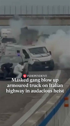 The Independent on Instagram: "This is the moment a masked gang who posed as police officers blew up an armoured truck during a heist on an Italian highway. Eyewitness footage shows several heavily armed men ducking behind parked cars as the cash van exploded on Sunday (8 February). They had already brought traffic to a standstill by setting fire to a different truck and using vehicles with flashing lights to pretend to be officers. Click the link in bio for more 🔗"