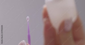 female hands apply primer to a brush before eyelash extension procedure Stock Video