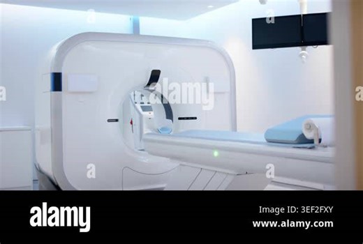 Scan is starting, CT gantry is advancing motorized patient table into bore for imaging. Scanner, radiology, diagnostic, equipment, clinical, sterile, minimalist Stock Video Footage - Alamy