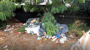 With trash bags and paintbrushes, volunteers transform area plagued by illegal dumping