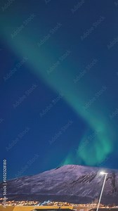 The aurora borealis northern lights time lapse in the sky (Vertical)