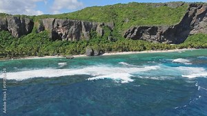 Aerial panoramic shot of Fronton beach with green coastline and crashing waves - Las Galeras, Dominican Republic