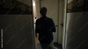 A young Mennonite woman walked into her room and sits down at a computer in slow motion.