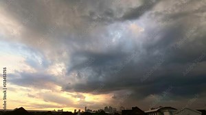 Epic scenic timelapse of massive puffy clouds moving and fading in the sky in sunset time