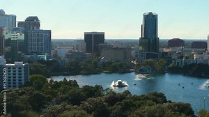 Orlando, Florida city architecture. Lake Eola Park and high-rise office buildings in downtown district. Real estate development in Florida. USA travel destination.