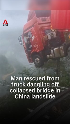 A driver and his cargo truck were seen hanging precariously over the edge of a collapsed bridge in Guizhou, China on Tuesday (Jun 24). A landslide triggered by heavy rainfall caused the structure to give way. In the video, the person filming could be heard telling the driver that there was no mobile connectivity and that he had to wait for the fire department to come rescue him. The driver was later brought to safety by emergency teams. #china #chinanews | CNA