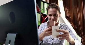 Woman scans check with QR code in office