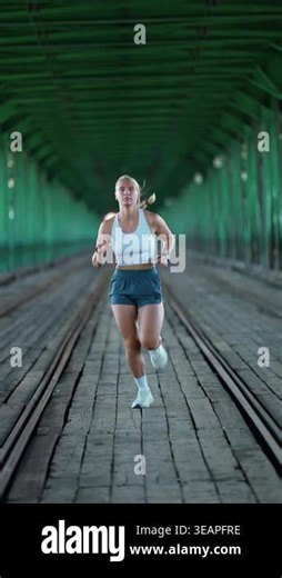 Warsaw, Poland - September 20, 2025: Wellness, Morning jog, sporty woman running through a bridge over the river, front view pro runner half-marathon training Stock Video Footage - Alamy