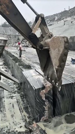 This excavator's clamshell bucket can be used to transport granite at a granite quarry #construction