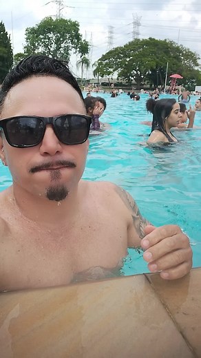 Muscular Man with Intricate Tattoos in Pool Setting
