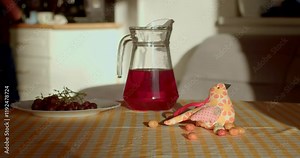 A friendly hand is joyfully interacting with a vibrant and colorful spread of delicious food and beautifully arranged drinks displayed on a table