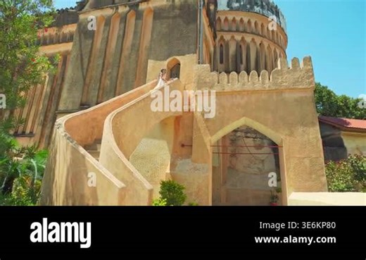 Caucasian Woman tourist wear white dress explores visit historic Christ Church Anglican Cathedral in Stone Town, Zanzibar. Features unique Gothic and Arabic coral stone in sunny day architecture Stock Video Footage - Alamy